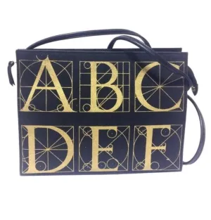 Vintage Paloma Picasso black canvas and leather combo shoulder bag with golden A B C D E F and S T V X Y letter print.